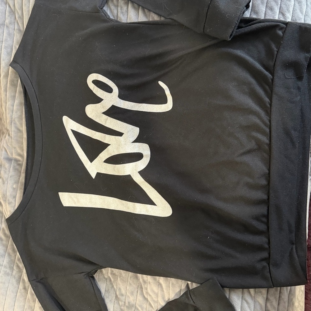 Black long sleeve off the shoulder top with Silver Love Graphic